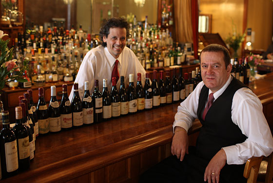 Bartender Carlos Chavez, left, poses with veteran waiter Eric Deljanin, right.