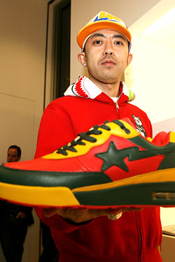 Nigo holding Air Max 90 BAPE sneakers.