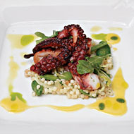 Grilled octopus with fregola and cara cara oranges.