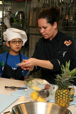 Stephanie Izard helps make chicken tacos at Common Threads.