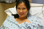A pregnant woman smiles as she plots her escape.