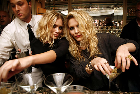 The Olsens bartending at Bergdorf Goodman.