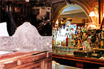 A sign carved with the name of August Lüchow is for sale. Inset: The bar at Café Remy.