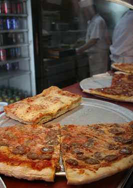 
Slices of sausage pizza ready to be eaten.