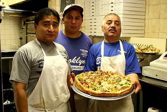 
Vinnie's staff displays its stuffed pizza.