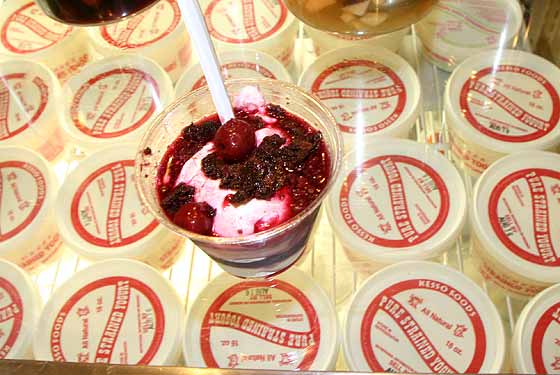 
Yogurt topped with chocolate, brownies, and cherries.