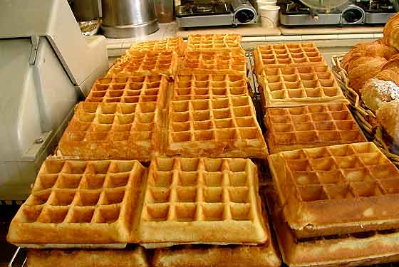 
Stacks of hot waffles on display.
