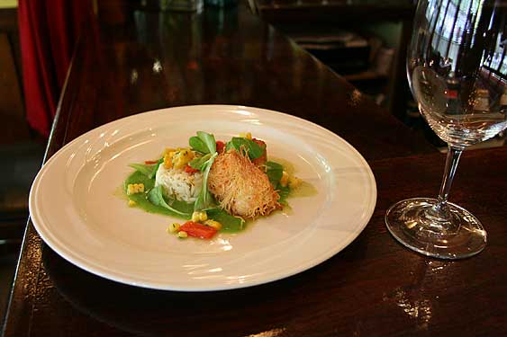 
A�diver scallop, a jumbo shrimp in phyllo, and lump crabmeat plated with pureed fava beans and salad. 