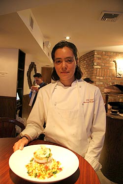 
Chef Andrea Luz Bergquist shows off her Merluzzo of pan-seared day boat cod, served with baccalà, lemon confit, roasted red peppers and sweet corn. 
